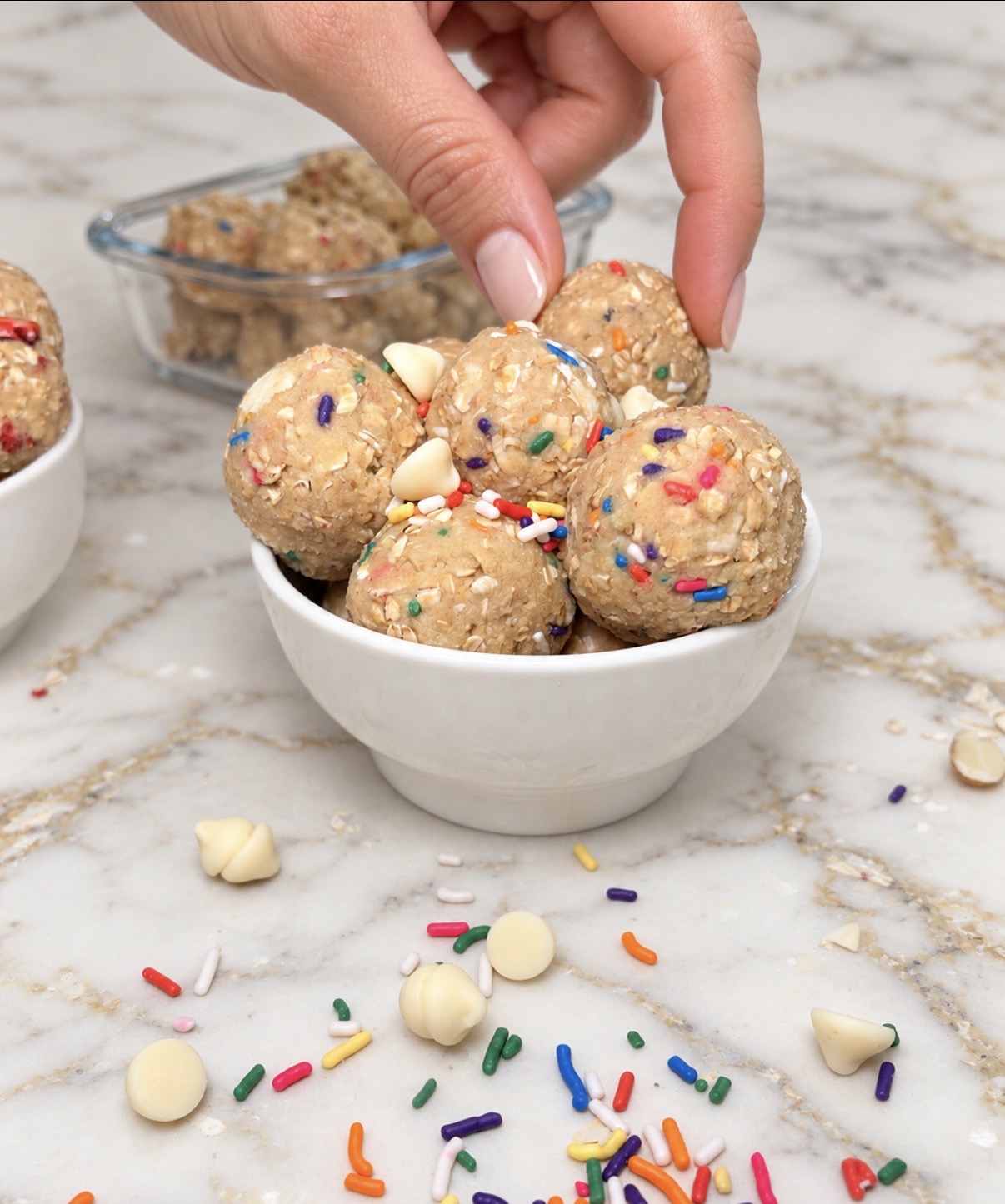 Birthday Cake protein balls in a bowl with sprinkles and white chocolate chips