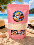 Crave Kits Birthday Cake Protein Ball Mix package displayed on a beach-themed background, featuring high-protein ready-to-make healthy treats with colorful sprinkles and a fun, dessert-inspired design.