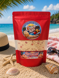 Crave Kits Strawberry Shortcake high-protein dessert mix bag showcased on a beach-themed backdrop with ocean scenery, highlighting a healthy and convenient protein snack.